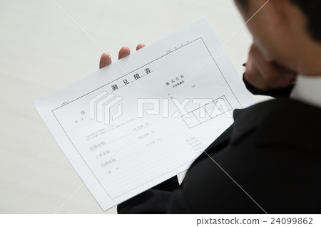 A man wearing a suit with an estimate A man wearing a suit with an estimate 24099862