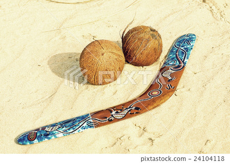 Boomerang and two coconuts on sandy beach Boomerang and two coconuts on sandy beach 24104118