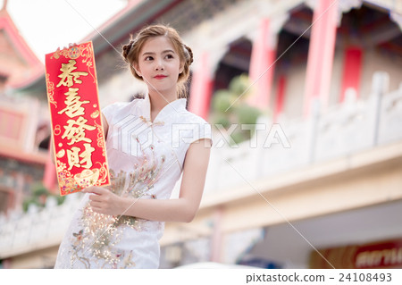 The Asian woman in chinese dress holding couplet ' 24108493