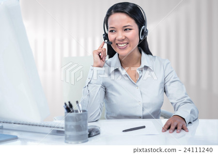 Composite image of smiling businesswoman using headset 24111240