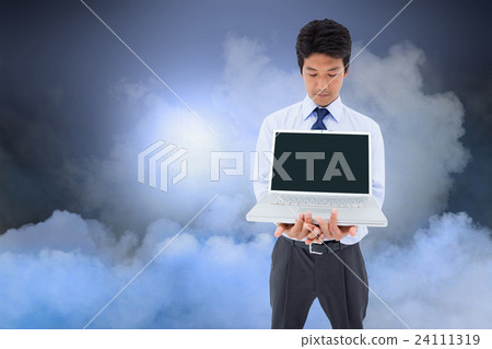 Composite image of businessman showing a laptop Composite image of businessman showing a laptop 24111319