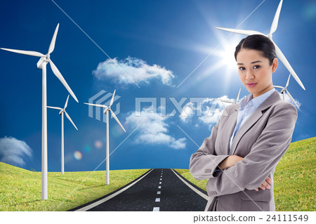 Composite image of portrait of a gorgeous businesswoman posing with the arms crossed 24111549