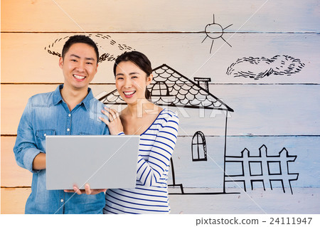 Composite image of portrait of couple using laptop 24111947
