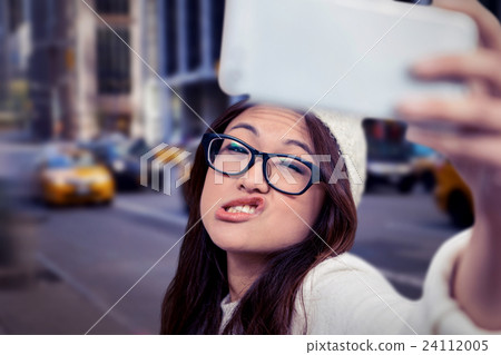 Composite image of asian woman making faces and taking selfie 24112005