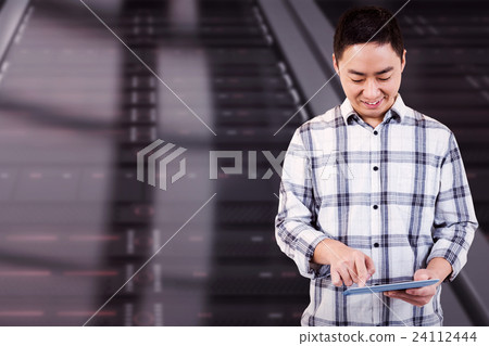 Composite image of cheerful man using tablet computer Composite image of cheerful man using tablet computer 24112444