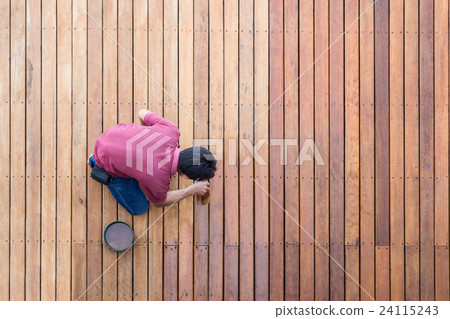 A man painting exterior wooden pool deck, Top view 24115243