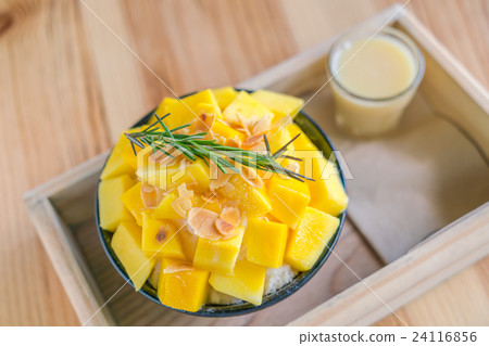 Korean style fresh mango shaved ice on wood table . 24116856