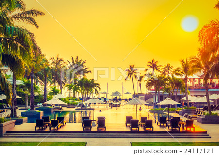 Beautiful Silhouette palm tree with umbrella and chair Beautiful Silhouette palm tree with umbrella and chair 24117121