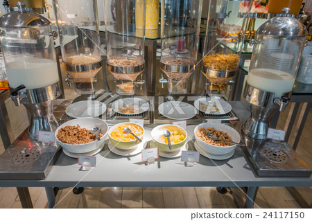 Cereal dispensers offering various kind of cereals in buffet at hotel restaurant . Cereal dispensers offering various kind of cereals in buffet at hotel restaurant . 24117150
