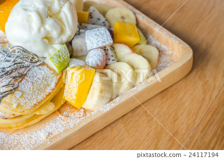 Pancake and fruit with ice cream on table . 24117194