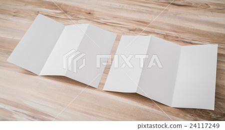 Trifold white template paper on wood texture . 24117249