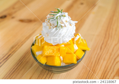 Korean style fresh mango shaved ice on wood table . 24118067