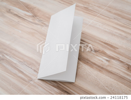 Trifold white template paper on wood texture . 24118175