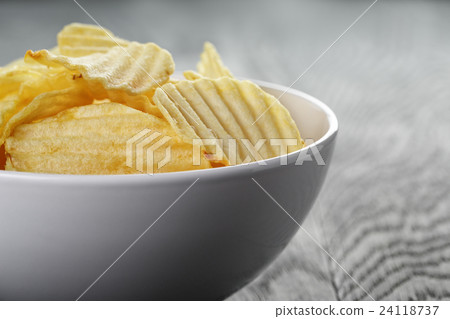 rippled organic chips in white bowl on wooden rippled organic chips in white bowl on wooden 24118737