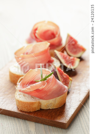canapes with jamon and figs on wooden board canapes with jamon and figs on wooden board 24120135