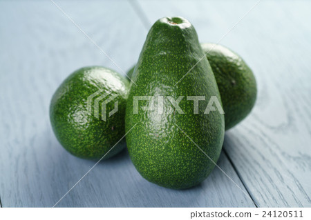ripe green avocados on blue wood table 24120511
