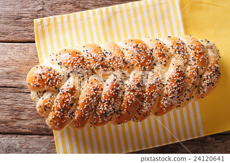 Freshly baked loaf of braided, with sesame seeds 24120641