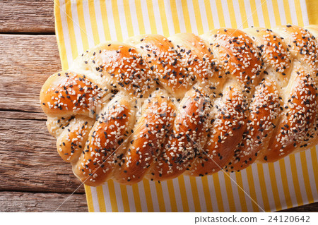 Tasty braided bun with sesame seeds closeup 24120642