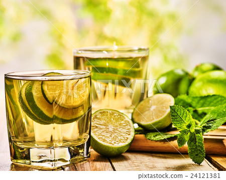 On wooden boards glasses with green transparent 24121381