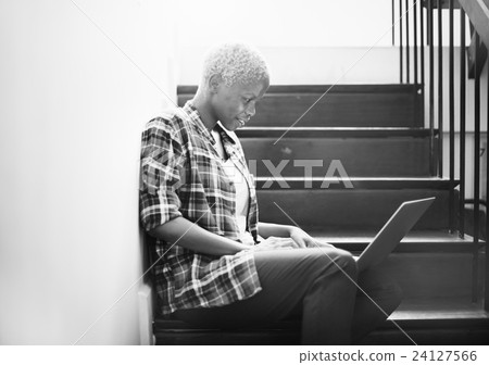 African Woman Searching Internet Sitting on Steps 24127566