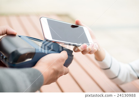 Customer pay with cellphone at outdoor cafe Customer pay with cellphone at outdoor cafe 24130988