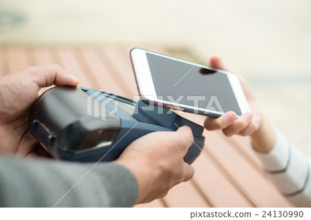 Woman pay on cellphone with NFC technology Woman pay on cellphone with NFC technology 24130990