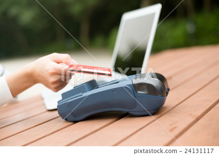 Woman using credit card to pay Woman using credit card to pay 24131117