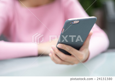 Woman using cellphone Woman using cellphone 24131380