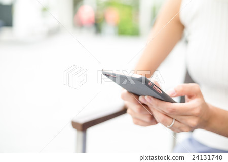 Woman using cellphone for text message Woman using cellphone for text message 24131740