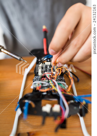 Man welding parts on drone body Man welding parts on drone body 24132163