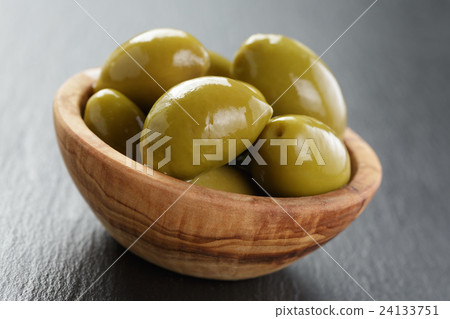 giant green olives in olive bowl on slate giant green olives in olive bowl on slate 24133751