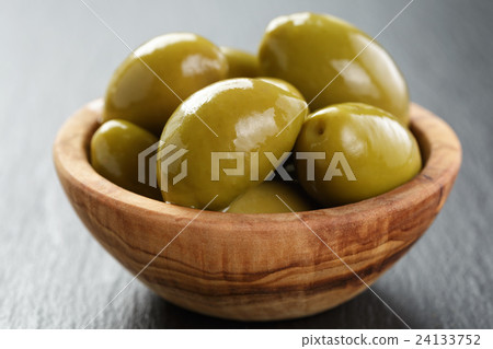 giant green olives in olive bowl on slate giant green olives in olive bowl on slate 24133752