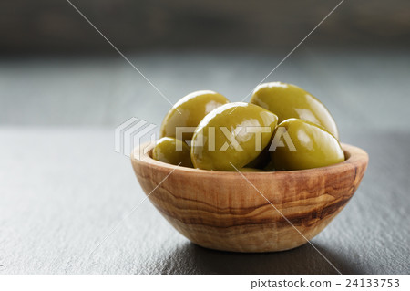 giant green olives in olive bowl on slate giant green olives in olive bowl on slate 24133753