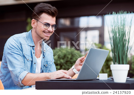 Content smiling man using laptop Content smiling man using laptop 24137920