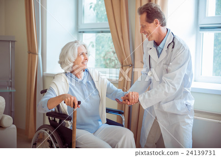 Nice doctor supporting senior woman Nice doctor supporting senior woman 24139731