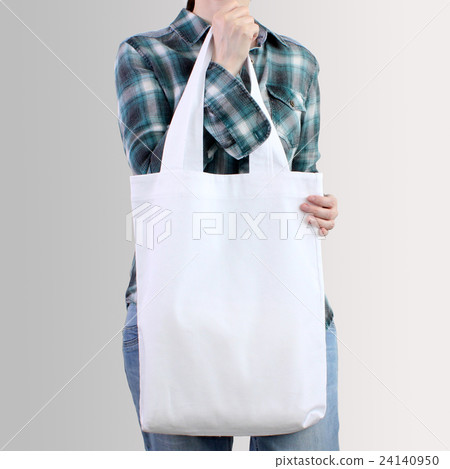 Girl is holding blank cotton tote bag, mockup. 24140950
