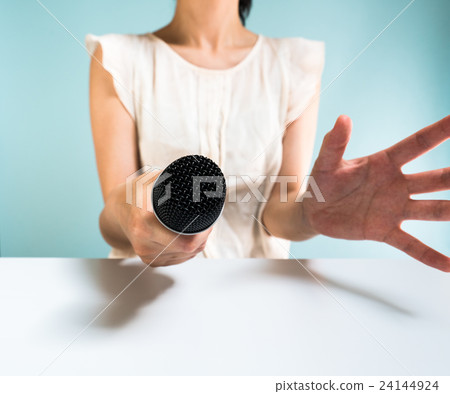 A woman pointing a microphone 24144924