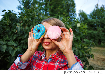 Cheerful girl and glasses of donuts Cheerful girl and glasses of donuts 24146315