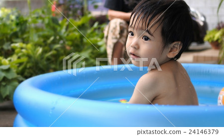 16: 9 Water play in a plastic pool 24146379