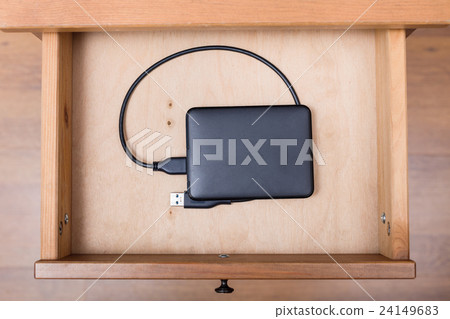 external computer hard drive in open drawer 24149683