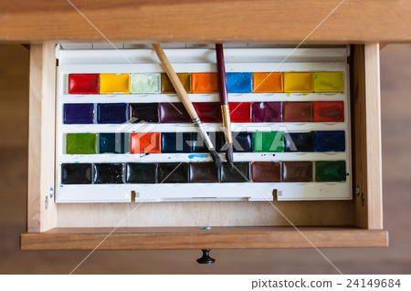 watercolor paints set and brushes in open drawer watercolor paints set and brushes in open drawer 24149684