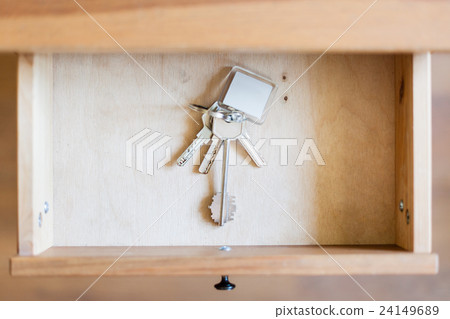 bunch of door keys with keyfob in open drawer bunch of door keys with keyfob in open drawer 24149689