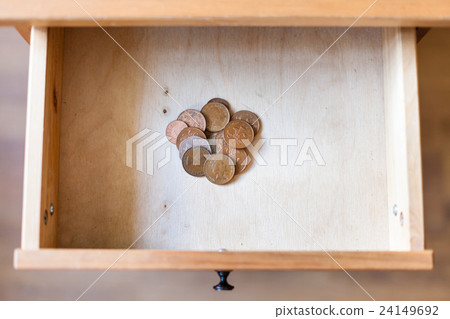 pile of british coins in open drawer 24149692