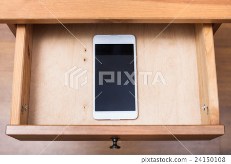 mobile phone in open drawer mobile phone in open drawer 24150108