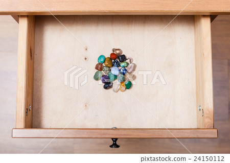 pile of gem stones in open drawer 24150112