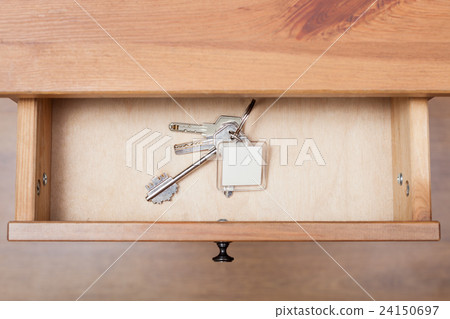 bunch of door keys with keychain in open drawer bunch of door keys with keychain in open drawer 24150697