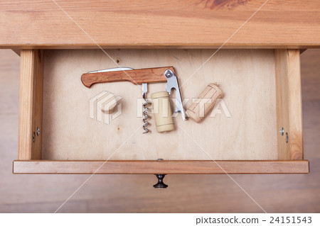 foldable corkscrew and corks in open drawer foldable corkscrew and corks in open drawer 24151543