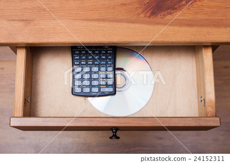 scientific calculator and disk in open drawer 24152311