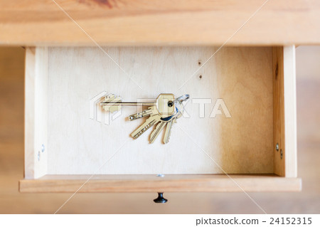 bunch of door keys in open drawer 24152315