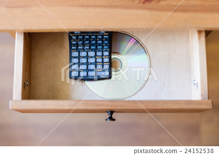 scientific calculator and a CD in open drawer scientific calculator and a CD in open drawer 24152538